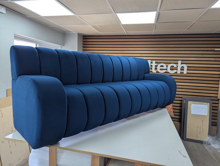Long channel-backed sofa in deep blue velvet