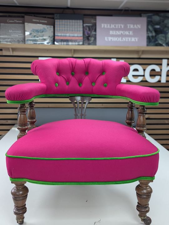 The tub chair after, deep-buttoned in fuchsia with lime-green piping